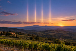 Quatre colonnes de lumière dans un ciel du soir au-dessus des vignes des Pyrénées-Orientales